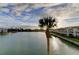 Scenic waterfront view featuring lush landscaping and canal access on a partly cloudy day at 12246 2Nd E St # 503, Treasure Island, FL 33706