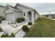 Gray one-story house with a two-car garage and landscaped front yard at 7855 Davie Ray Dr, Zephyrhills, FL 33540