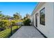 Enjoy outdoor living on this private paved patio, featuring modern black metal railings and lush tropical landscaping at 2355 Bahia Vista St, Sarasota, FL 34239