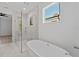 Spa-like bathroom featuring a freestanding tub and glass shower at 2355 Bahia Vista St, Sarasota, FL 34239