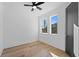 Well-lit bedroom with hardwood floors, ceiling fan, and modern trim at 2355 Bahia Vista St, Sarasota, FL 34239