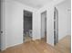 Light and bright hallway with hardwood floors and access to bedrooms at 2355 Bahia Vista St, Sarasota, FL 34239
