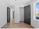 Hallway with hardwood floors, contemporary trim, and neutral paint at 2355 Bahia Vista St, Sarasota, FL 34239