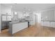 Open-concept kitchen featuring white cabinets, gray countertops, and hardwood floors at 2355 Bahia Vista St, Sarasota, FL 34239