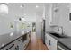 Open-concept kitchen featuring white cabinets, gray countertops, and hardwood floors at 2355 Bahia Vista St, Sarasota, FL 34239
