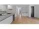 Stylish kitchen with gray countertops, white cabinets, stainless steel appliances, and hardwood floors at 2355 Bahia Vista St, Sarasota, FL 34239