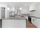 Stylish kitchen with gray countertops, white cabinets, stainless steel appliances, and hardwood floors at 2355 Bahia Vista St, Sarasota, FL 34239