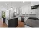Stylish kitchen with gray countertops, white cabinets, stainless steel appliances, and hardwood floors at 2355 Bahia Vista St, Sarasota, FL 34239