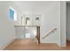 Well-lit hardwood staircase with a modern black railing, enhancing the home's contemporary style at 2355 Bahia Vista St, Sarasota, FL 34239