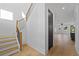 Elegant hardwood staircase with a black and wood railing, adjacent to a modern hallway entrance at 2355 Bahia Vista St, Sarasota, FL 34239