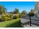 Steps from the lawn to the back patio, featuring modern black metal railings and lush tropical landscaping at 2355 Bahia Vista St, Sarasota, FL 34239