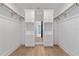 Walk-in closet with custom shelving and storage and hardwood flooring at 2355 Bahia Vista St, Sarasota, FL 34239