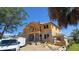 New two-story home under construction, showing the block foundation and wood framing with a worker on the roof at 567 Luzon Ave, Tampa, FL 33606