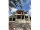 Under construction, the home features a two-story design with a balcony, large windows, and an attached two-car garage at 567 Luzon Ave, Tampa, FL 33606