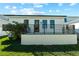 Back porch with brick flooring, metal railings, and a lush backyard at 2365 Bahia Vista St, Sarasota, FL 34239