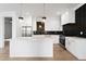 Modern kitchen featuring white cabinets, a large island, stainless steel appliances, and modern backsplash at 2365 Bahia Vista St, Sarasota, FL 34239