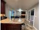 Kitchen view from the Gathering room, granite countertops, stainless steel appliances, and dark wood cabinets at 2602 Arrawana Pl, Tampa, FL 33614