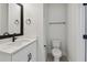 Clean bathroom with white toilet and vanity with black fixtures at 460 31St N Ln, St Petersburg, FL 33713