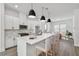 Modern kitchen with white cabinets, quartz countertops, and island at 460 31St N Ln, St Petersburg, FL 33713