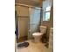 Clean bathroom with shower/tub combo, toilet, and vanity with wood cabinets at 10911 Hachita Dr, Port Richey, FL 34668