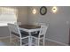 Charming dining room with a white table and gray cushioned chairs at 10911 Hachita Dr, Port Richey, FL 34668