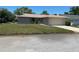 Single-story home with attached garage and well-maintained lawn at 10911 Hachita Dr, Port Richey, FL 34668