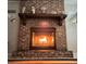 Brick fireplace with a modern insert and decorative mantel at 10911 Hachita Dr, Port Richey, FL 34668