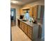 Kitchen with light wood cabinets, granite countertops and stainless steel appliances at 10911 Hachita Dr, Port Richey, FL 34668