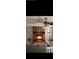 Cozy living room featuring a brick fireplace and ceiling fan at 10911 Hachita Dr, Port Richey, FL 34668