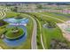 Aerial view of community showing homes, roads, and a large lake at 31396 Cabana Rye Ave, San Antonio, FL 33576