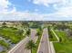 Aerial view of community with palm trees, roads, and a circular water feature at 31396 Cabana Rye Ave, San Antonio, FL 33576