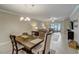 Bright dining room with wood table and chairs, adjacent to kitchen at 31396 Cabana Rye Ave, San Antonio, FL 33576
