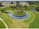 Aerial view of community entrance with a unique water feature and landscaping at 31396 Cabana Rye Ave, San Antonio, FL 33576