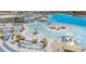 Aerial view of a resort-style lagoon with beach access and water features at 31396 Cabana Rye Ave, San Antonio, FL 33576