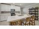 Modern kitchen with white cabinets, island, and stainless steel appliances at 31396 Cabana Rye Ave, San Antonio, FL 33576