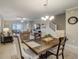 Dining room with a rustic table and chairs, overlooking the living room at 31396 Cabana Rye Ave, San Antonio, FL 33576