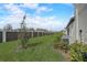 Landscaped backyard with a privacy fence and AC units at 31396 Cabana Rye Ave, San Antonio, FL 33576