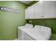Convenient laundry room with washer, dryer, and cabinets at 31396 Cabana Rye Ave, San Antonio, FL 33576