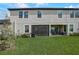 Home's backyard features a screened patio, grassy lawn, and grill at 31396 Cabana Rye Ave, San Antonio, FL 33576
