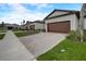 Two-story home with a brick paved driveway and attached garage at 31396 Cabana Rye Ave, San Antonio, FL 33576