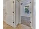 Bathroom with tan tile floors, white doors, and access to bedroom at 20026 Heritage Point Dr, Tampa, FL 33647