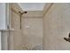 Shower with beige tile and pebble stone flooring at 20026 Heritage Point Dr, Tampa, FL 33647