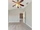 Spacious bedroom with ceiling fan and access to hallway at 20026 Heritage Point Dr, Tampa, FL 33647