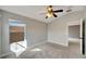 Well-lit bedroom with ceiling fan and access to another room at 20026 Heritage Point Dr, Tampa, FL 33647
