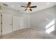 Spacious bedroom featuring double doors and ceiling fan at 20026 Heritage Point Dr, Tampa, FL 33647