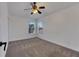 Bright bedroom with a window, ceiling fan, and carpet flooring at 20026 Heritage Point Dr, Tampa, FL 33647