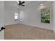 Large bedroom with neutral carpeting and ceiling fan at 20026 Heritage Point Dr, Tampa, FL 33647