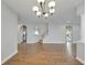 Elegant dining room showcasing hardwood floors and a modern chandelier at 20026 Heritage Point Dr, Tampa, FL 33647