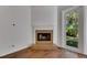 Corner fireplace with marble surround and backyard view at 20026 Heritage Point Dr, Tampa, FL 33647