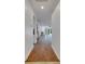 Long hallway with hardwood floors leading to living area at 20026 Heritage Point Dr, Tampa, FL 33647